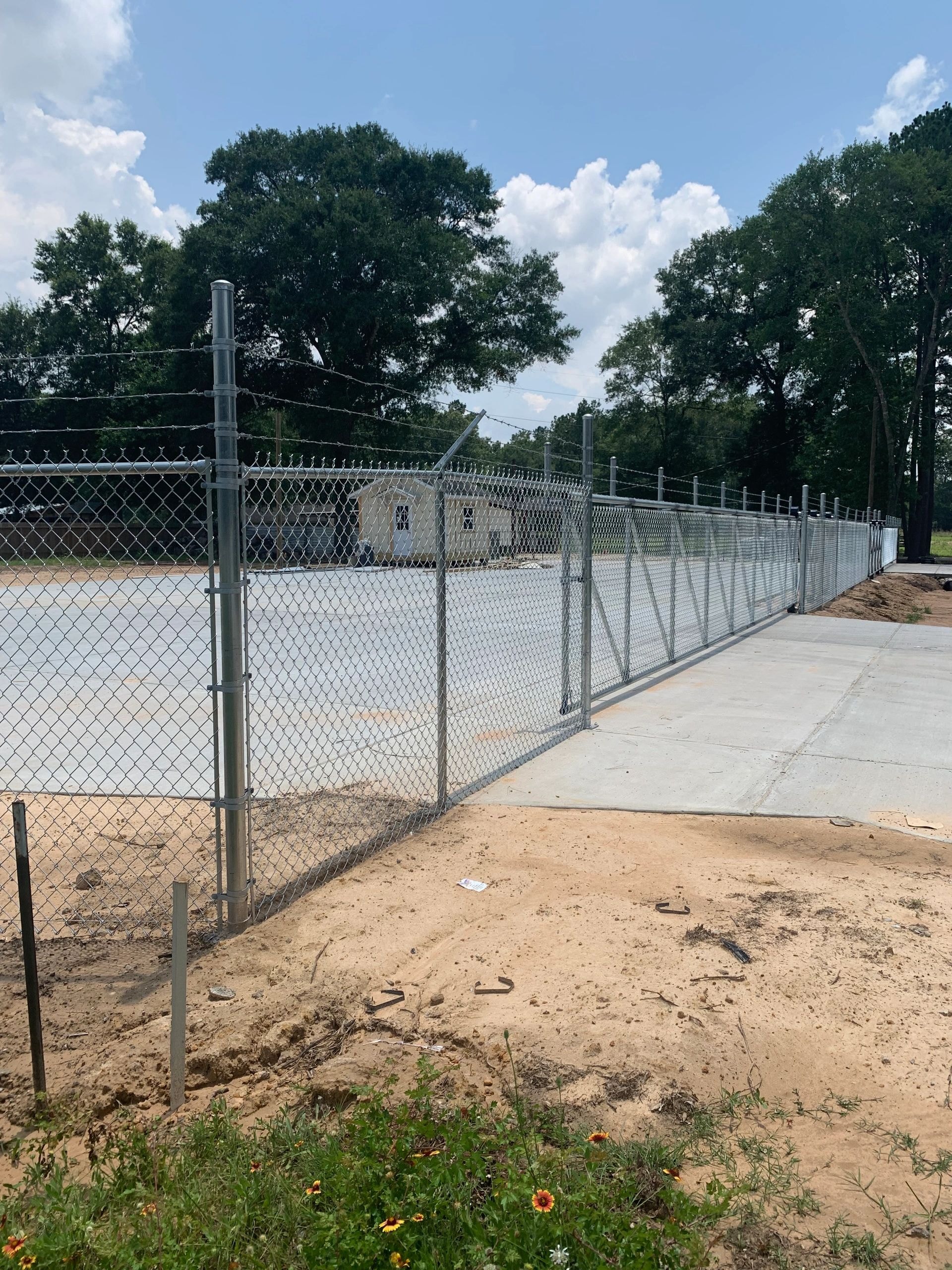 Metal chain-link fence surrounding sports field