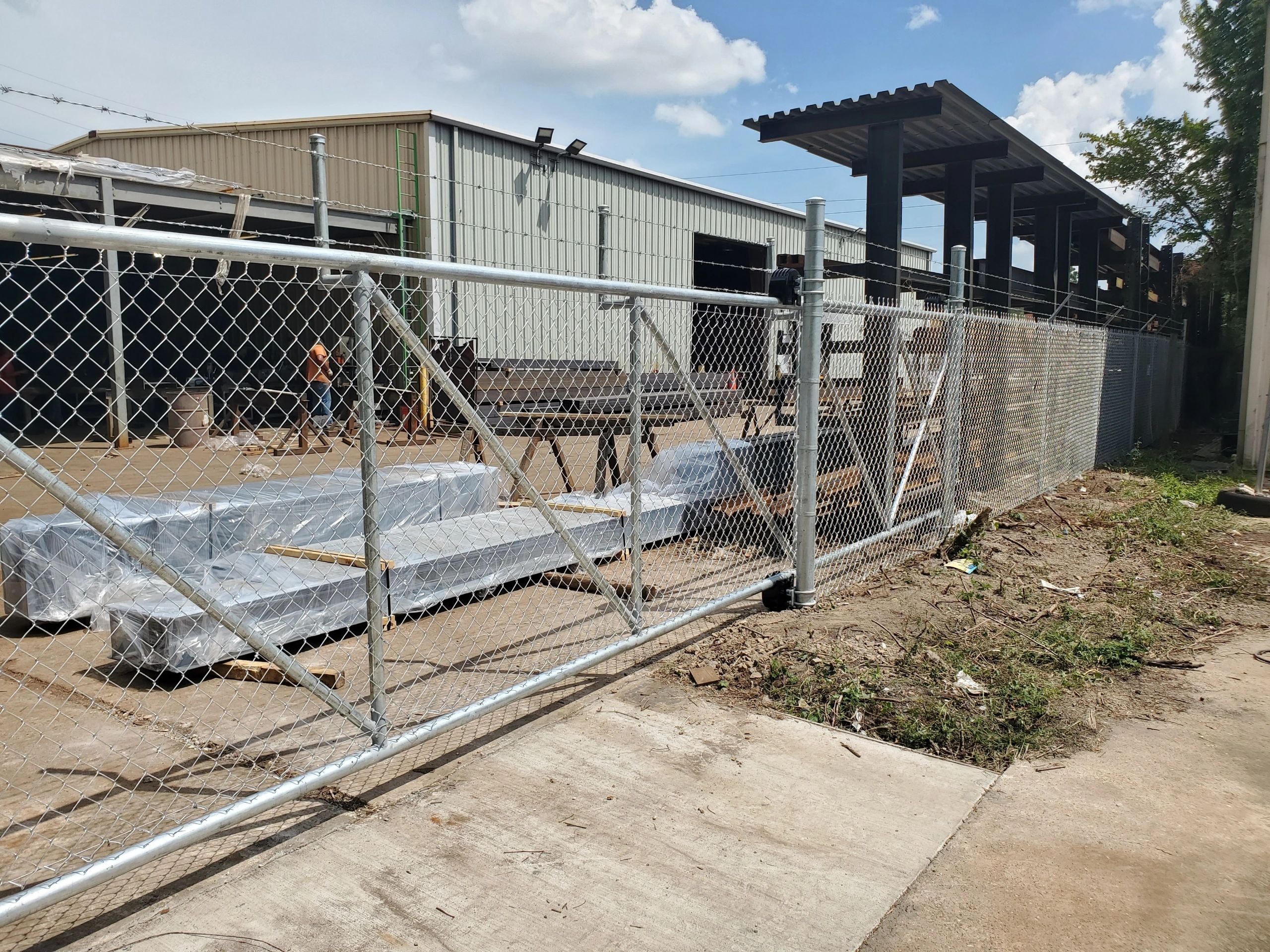 Industrial construction site with chain-link fence